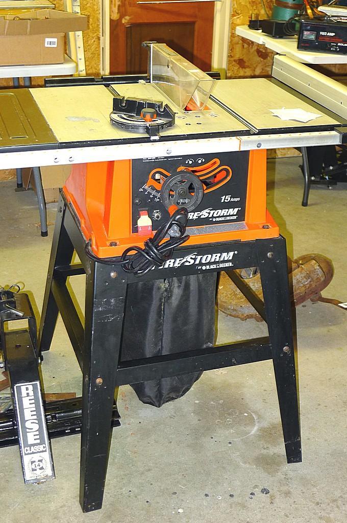 Black and Decker FireStorm 10 table saw with steel floor stand and dust  collection bag. Table with