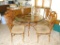 4' diameter glass top table with six chairs. Entire set is metal framed and in very good condition