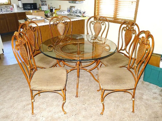 4' diameter glass top table with six chairs. Entire set is metal framed and in very good condition