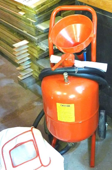 5 gallon pressurized sand blaster with face hood, fill funnel and directions. Appears near new.