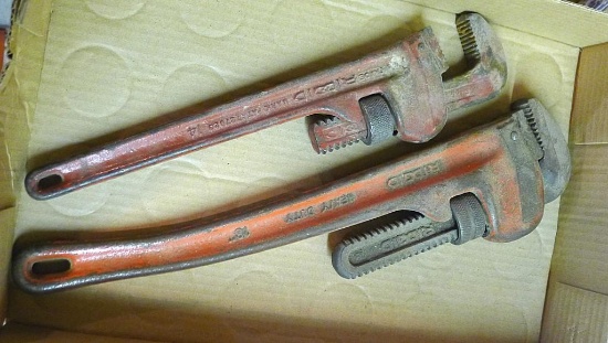 Two Ridgid pipe wrenches, 14" & 18". The 18" handle is bent. Jaws show wear.