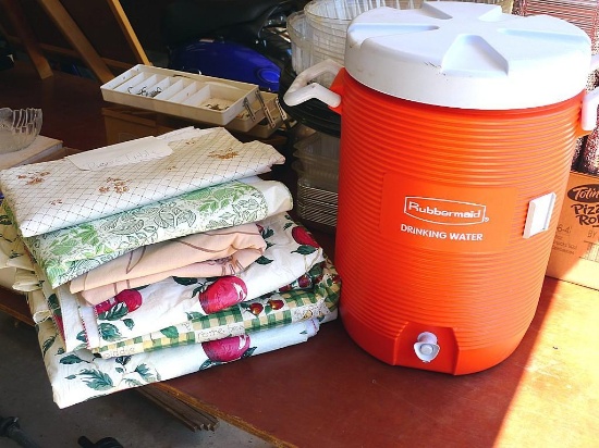 Rubbermaid 5 gallon water cooler, assorted vinyl tablecloths and one more. Some tablecloths have