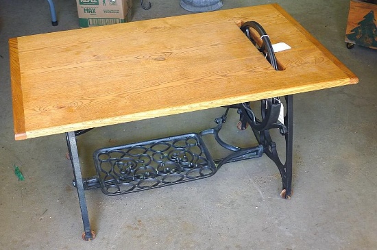 Ash coffee table with antique sewing cabinet legs and wheel. Approx. 20" x 34" x 17". In good shape.