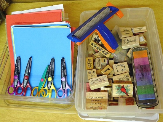 Rubber stamps, inkpad, decorative scissors, crimper and paper.