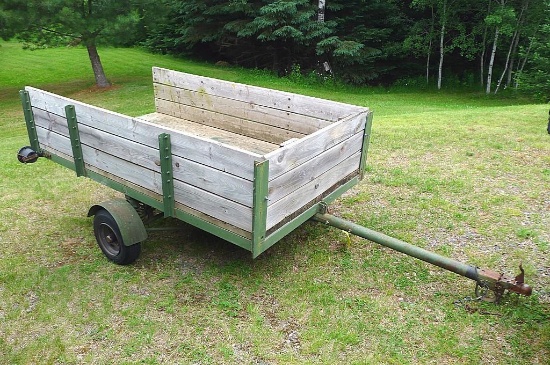 Two wheel metal framed trailer with wood sides and bottom. Approx. 7' x 4' x 17" high. Tire size is