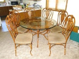 4' diameter glass top table with six chairs. Entire set is metal framed and in very good condition