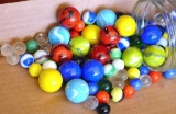 Quart jar of assorted glass marbles.