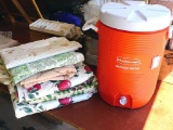 Rubbermaid 5 gallon water cooler, assorted vinyl tablecloths and one more. Some tablecloths have