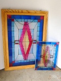 Two beautiful stain glass wall hangings, one has a wood frame and is 19