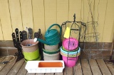 Large assortment of garden supplies incl. tomato cages, water can, planters and more.