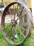 Antique steel tractor wheel, 4 ft. Nice yard decoration.