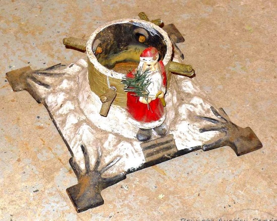Neat cast iron Christmas tree stand with vintage looking Santa. Base is approx. 11" square and takes