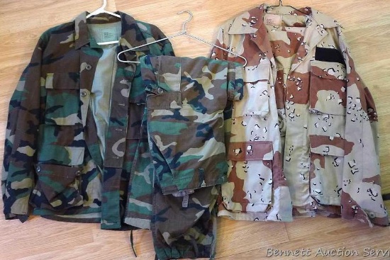 One green/brown camo and one desert camo uniform. Green/brown camo shirt is size Medium-Short, pants