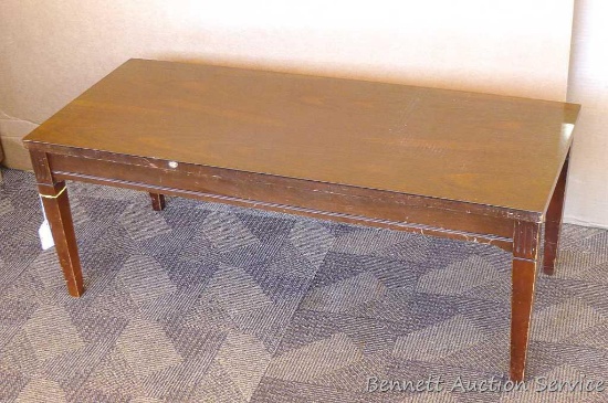 Mersman coffee table with laminated top, approx. 41" l x 17" w x 16" h. Has some scratches and