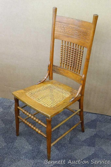 Antique oak pressed back chair appears in good condition, is 18" x 42" tall x 16" and was donated by
