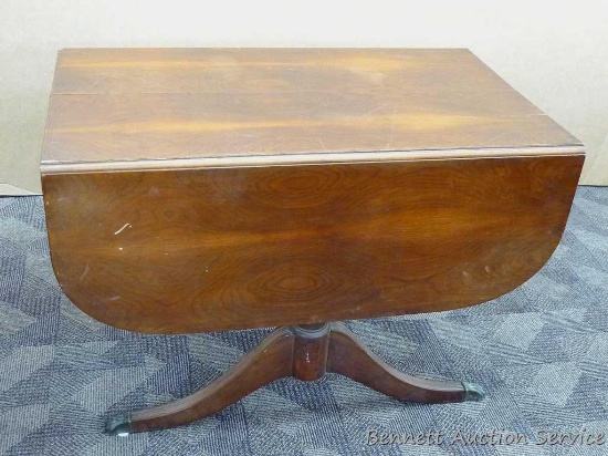 Wooden drop leaf table with metal claw feet is 56" x 42" x 28" with leaves up, has some chipped