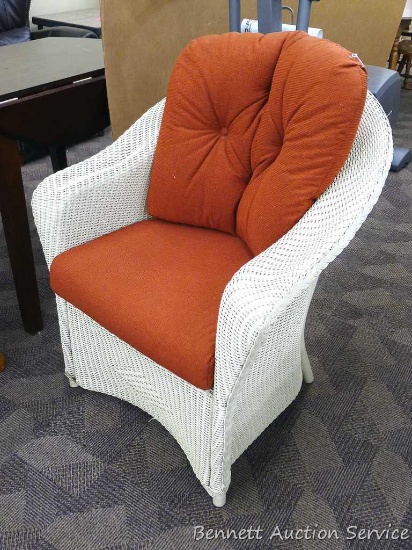 Padded wicker chair is 30" x 34" x 28" deep and appears in good condition. Donated by Andrea & Kevin