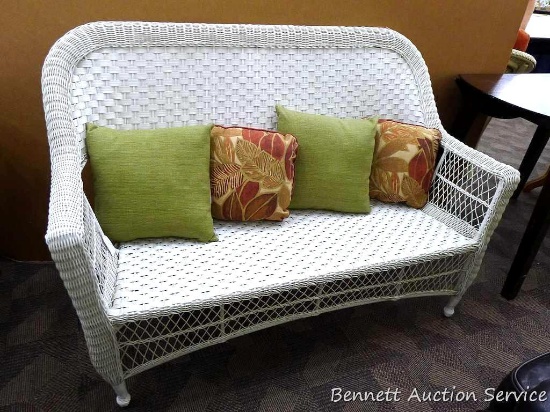 Beautiful wicker love seat with 4 decorative pillows is 5' long x 38" tall x 18" deep and appears in