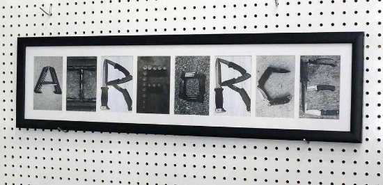 Framed "Air Force" print with each letter a collage of weaponry is 35-1/2" x 9-1/2" and was donated