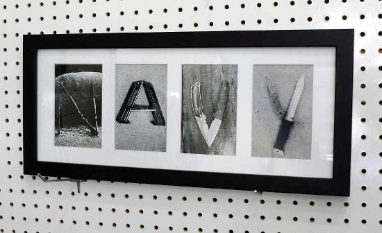 Framed "Navy" print with each letter a collage of weaponry is 21-1/2" x 9-1/2" and was donated by