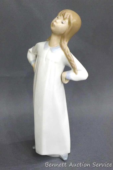 Lladro girl in nightgown stands approx. 8" tall and is in good condition with no cracks or chips