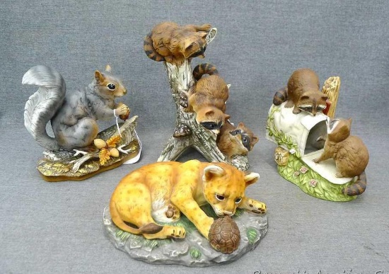 Four vintage and newer Home Interior wild life figurines including squirrel, racoons and bobcat.