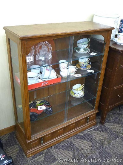 Cabinet with glass door fronts and adjustable glass shelves; bottom drawer across the bottom;