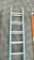 Werner 28 ft fiberglass extension ladder, 250 lb rating, bottom of left rail on top section is