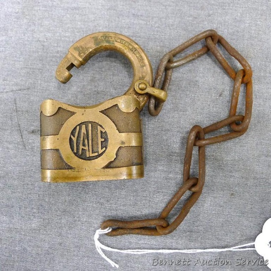 Vintage cast brass Yale padlock is stamped "Bell System" and is unlocked but without key.