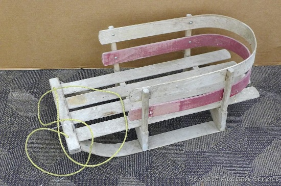 Adorable vintage wooden sled. Approx. 28-1/2" l x 15" w. One of the sled runners is broken in back.