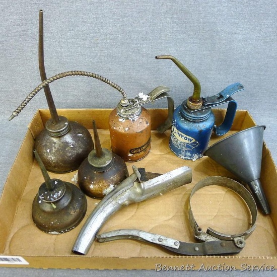 Assortment of oil cans, tallest 10-1/2"; oil filter wrench; metal funnel; oil can spout.