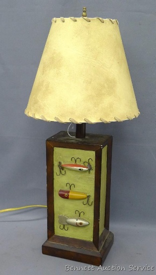 Rustic lamp with faux fishing lures, works. Lamp shade shows scene with bear. measures 25"x 12".