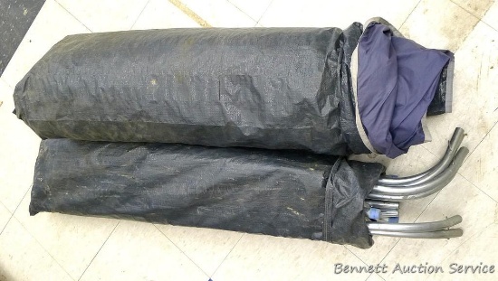 Metal-pipe framed tent, size and condition are unknown.  Looks well cared for.