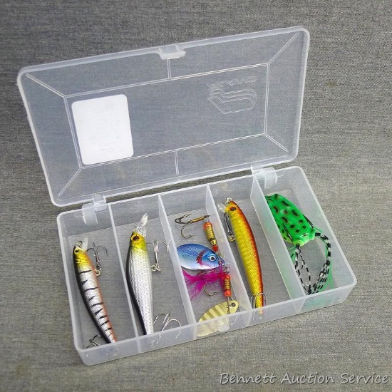 5 fishing lures in an approximately 6-1/2"x 3-3/4" Plano box. Includes spinners and a frog lure. All