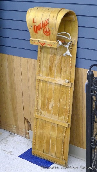 Le Quebec wooden child's toboggan is marked FAIT. AU. CANADA. Measures 48"x 14". Shows wear from