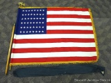 Vintage United States 48 star flag with 10 foot carry pole and cast brass eagle. Flag is approx. 7'