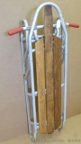 Vintage aluminum framed sled has front steering and appears to be in good condition. Measures 15