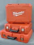 Three Milwaukee storage cases, largest is 22