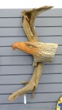 Eagle head hand carved out of a piece of driftwood is a unique piece. Dimensions are 14