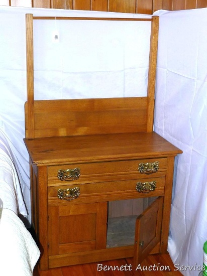 Pretty little antique oak wash stand with two dovetailed drawers and towel harp. Piece measures