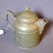 Fun metal tea pot has a decorative handle, spout and top. Stands 8