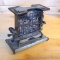 Antique Universal toaster with swing arm on each side to rotate toast. Base measures 7-3/4