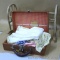 Child's suitcase full of antique doll clothes, plus an 18