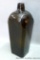 Brown green bitters bottle with circle and five dots pattern on the bottom. Dump dug bottle has a