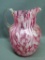 Beautiful pink and white blown glass pitcher has applied handles and stands approx. 9-1/2