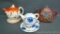 Three cute little tea pot sets as pictured. Blue and white floral set includes a cup and saucer.