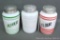 Three vintage shakers including green Pepper, red Flour and an unmarked white shaker. Each piece is