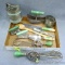 Vintage green handled kitchen utensils including beaters, choppers, sifters, scoop, spreader, jar