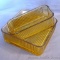 Two yellow or gold glass refrigerator dishes, both missing lids. Dishes are an 8