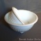 Pair of white nesting mixing bowls have rib and scallop design. Smaller bowl measures 8-1/4